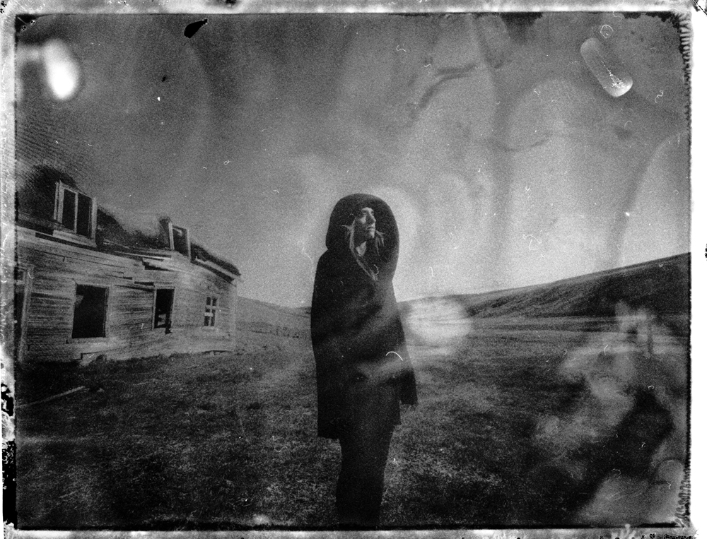 hooded person and abandoned traditional turf house church in Iceland Fine art Polaroid photography by Guðmundur Óli Pálmason kuggur.com